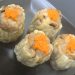 a group of white and orange sushi rolls